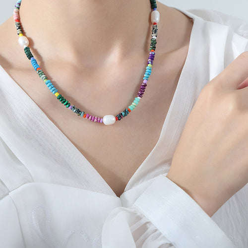 Multicolor disc bead pearl necklace worn on chest
