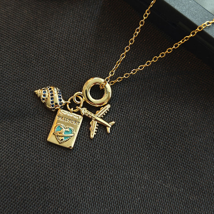Passport Airplane and Shell Travel Charm Necklace in Gold Tone