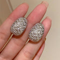 Oval Pave Scrollwork Clip-On Earrings In Gold And Silver Tones view 2