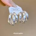 Layered Silver Tone Hoop Earrings with Black Dot Details view 2