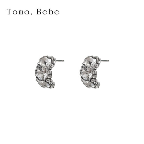 Curved three-stone CZ pair on white background
