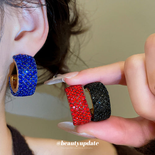 crystal pave wide c hoop earrings in black and red shown in an on-ear styling view