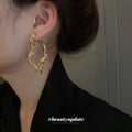Gold Textured Wavy Open Hoop Earrings Polished Metal Jewelry view 1