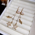 Gold Tone Coastal Charm Hook Earrings in Three Colors view 7