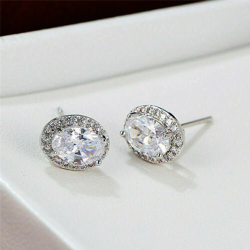 Silver oval clear halo studs pair on white display block