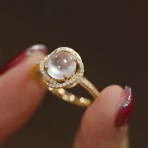 Duplicate angled close-up of gold moonstone look halo ring