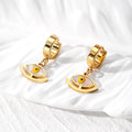 Gold Tone Evil Eye Huggie Drop Earrings in Five Designs view 2