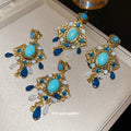 Gold Tone Blue Cabochon And Teardrop Chandelier Earrings view 2