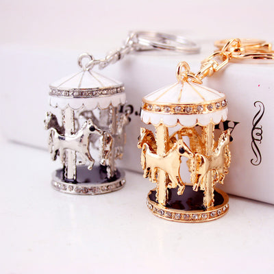 Gold-tone and silver-tone carousel horse keychains displayed together.