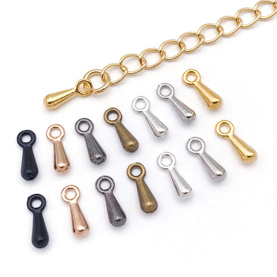 Metallic extender chain jewelry findings arranged on a light background