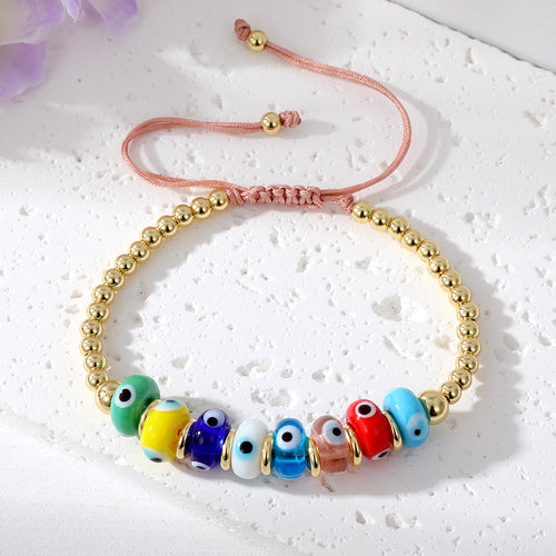 Close-up showing the colors and surface details of gold Tone Beaded Cord Evil Eye Adjustable Bracelets in Seven Styles