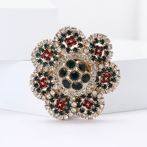 Angled display of the round crystal flower brooch with antique gold petal setting