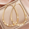 Brass Gold-Tone Twisted Teardrop Hoop Earrings in Three Sizes view 3