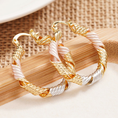 Alternate close view of the gold, silver, and rose gold tones earrings