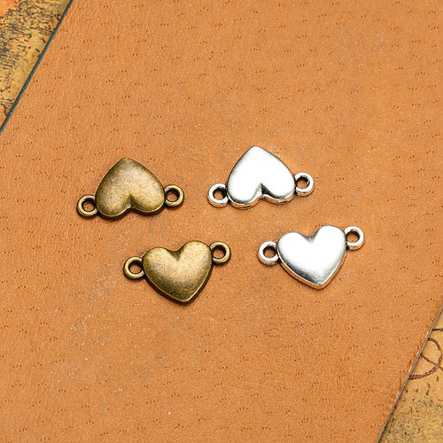 Small heart connector components displayed in multiple metal finishes