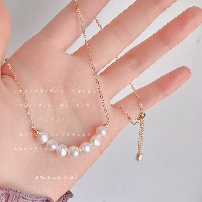 Gold Tone Chain Necklace With Graduated White Pearl Curved Centerpiece