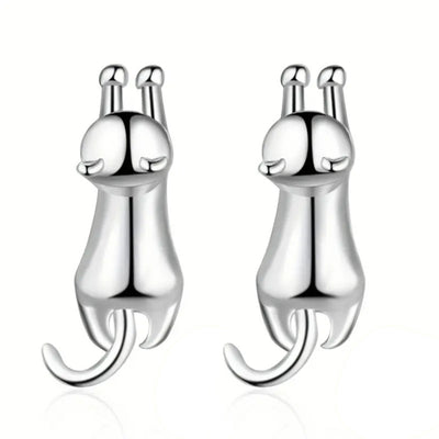Pair of silver stretching cat stud earrings on white background