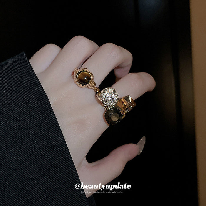 Three Mixed Statement Rings With Brown Crystals Green Or Brown Stones