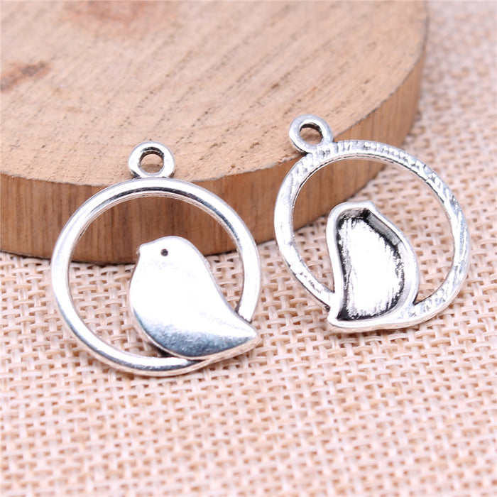 Bird in Round Frame Metal Charm Pendant in Two Finishes