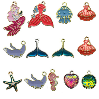 Colorful starfish and mermaid charms arranged on a light background