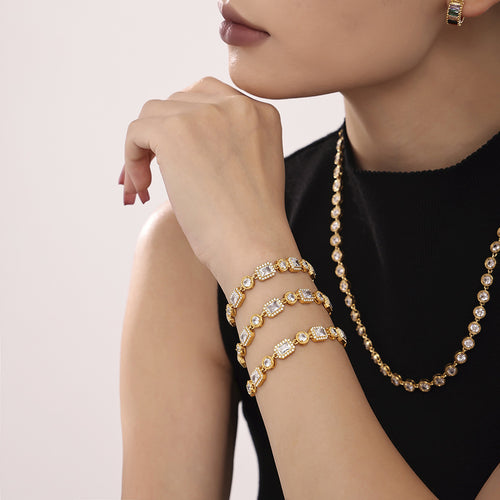 Three gold geometric zircon bracelets stacked on wrist