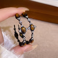 Dark Metal Hoop Earrings with Brown Oval Cabochons view 3