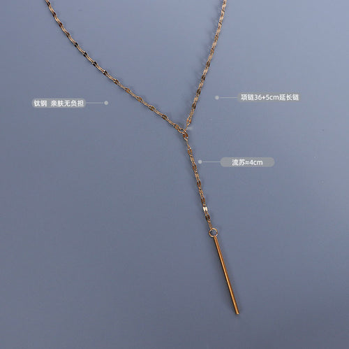 Flat lay gold Y necklace with length and tassel labels