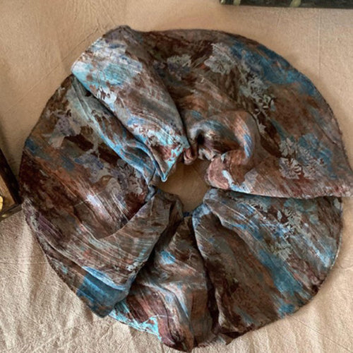 Blue brown cream abstract floral oversized scrunchie laid flat on linen
