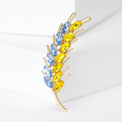 Front view of blue and yellow crystal wheat stalk brooch in gold tone