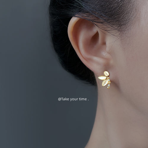 Gold peach butterfly stud worn on ear side profile