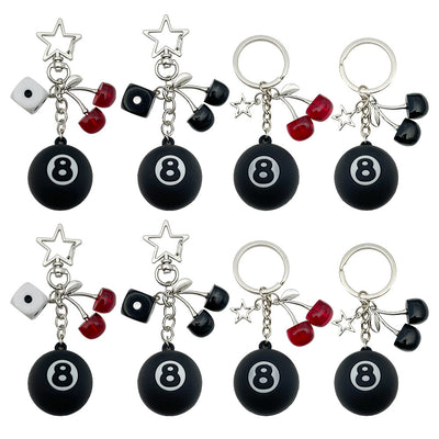 Front display of four black 8 ball keychains with dice and cherries with visible colors and attached hardware