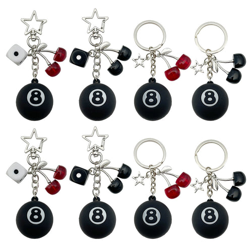Front display of four black 8 ball keychains with dice and cherries with visible colors and attached hardware
