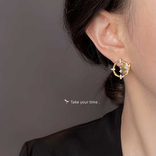 Gold bamboo star circle stud worn on ear profile