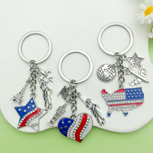 Image 1 showing three key chains with charms and a flower.