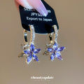 Purple Crystal Flower Huggie Earrings With Decorative Metal Details view 1