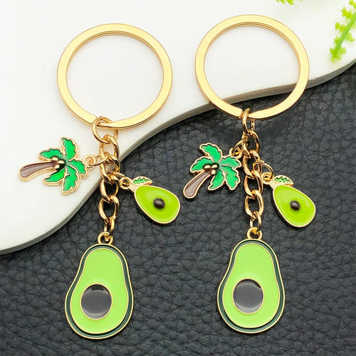 Grouped three rabbit lemon and avocado enamel keychains arranged together on a styled display surface