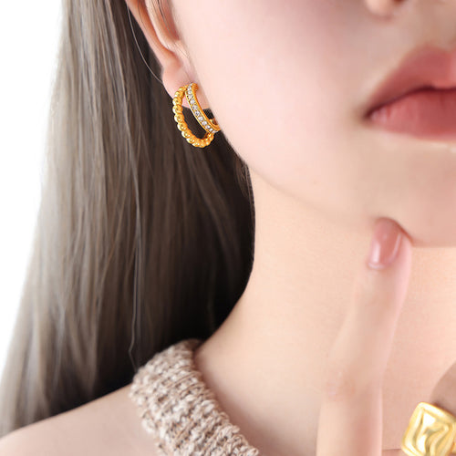 On-ear view of double hoop crystal earrings in main image 1.