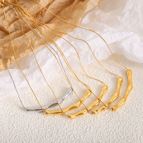 Several gold and one steel wavy bar necklaces fanned out