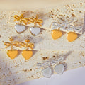 Bow Heart Drop Stud Earrings Gold Steel And Two-Tone view 1