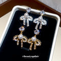 Bow Pearl Drop Stud Earrings In Silver And Gold Tones view 4