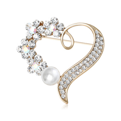 Front view of the crystal heart brooch with pearl drop in two tones with polished metal detail on a white background