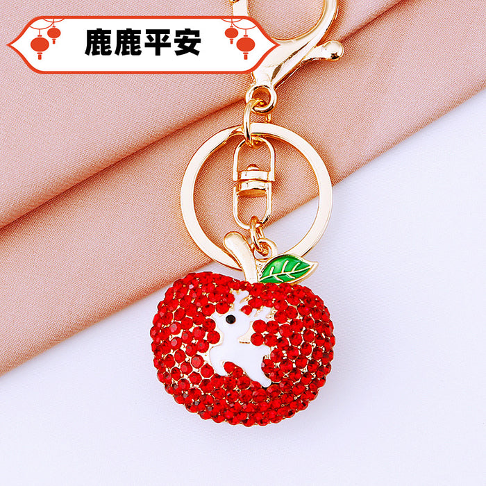 Jeweled Red Apple Keychain with White Deer Silhouette and Green Leaf