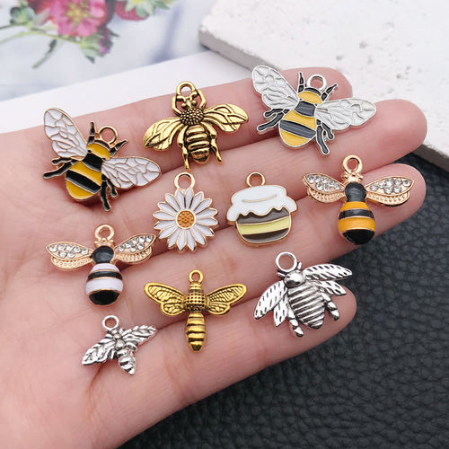 Colorful bee and daisy charms shown in a close-up product view