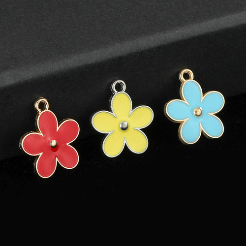 Three daisy flower charms in red, yellow and blue enamel with metal frames on a dark surface
