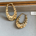 Textured Open Oval Huggie Earrings with Polished Metal Tone Details view 7