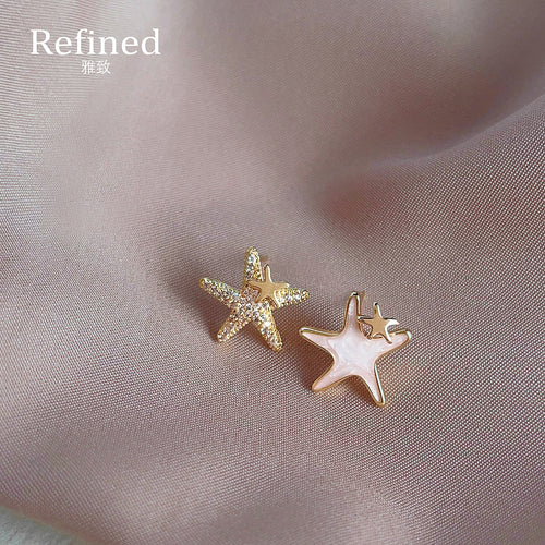 Gold asymmetric white enamel and pave crystal starfish studs on pink silk