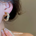White Flower And Green Leaf Hoop Clip On Earrings With Polished Metal Details view 3
