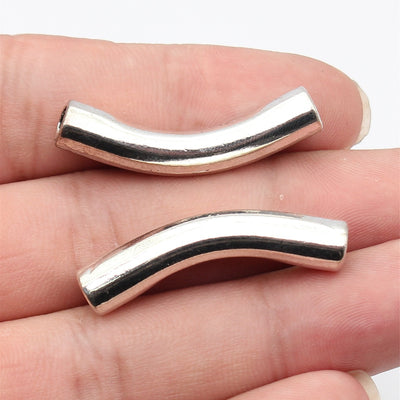 Antique Silver curved smooth tube spacer bead shown in front view