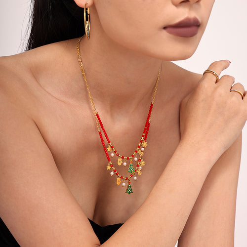 Side view layered red garnet Christmas charm necklace on model