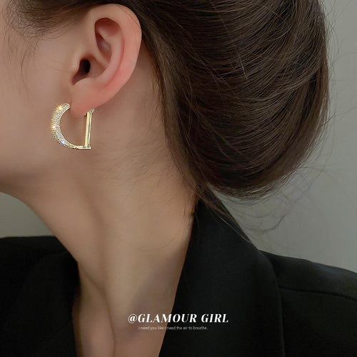Crystal Paved Letter D Huggie Hoop Earrings Polished Metal Jewelry modeled at the ear